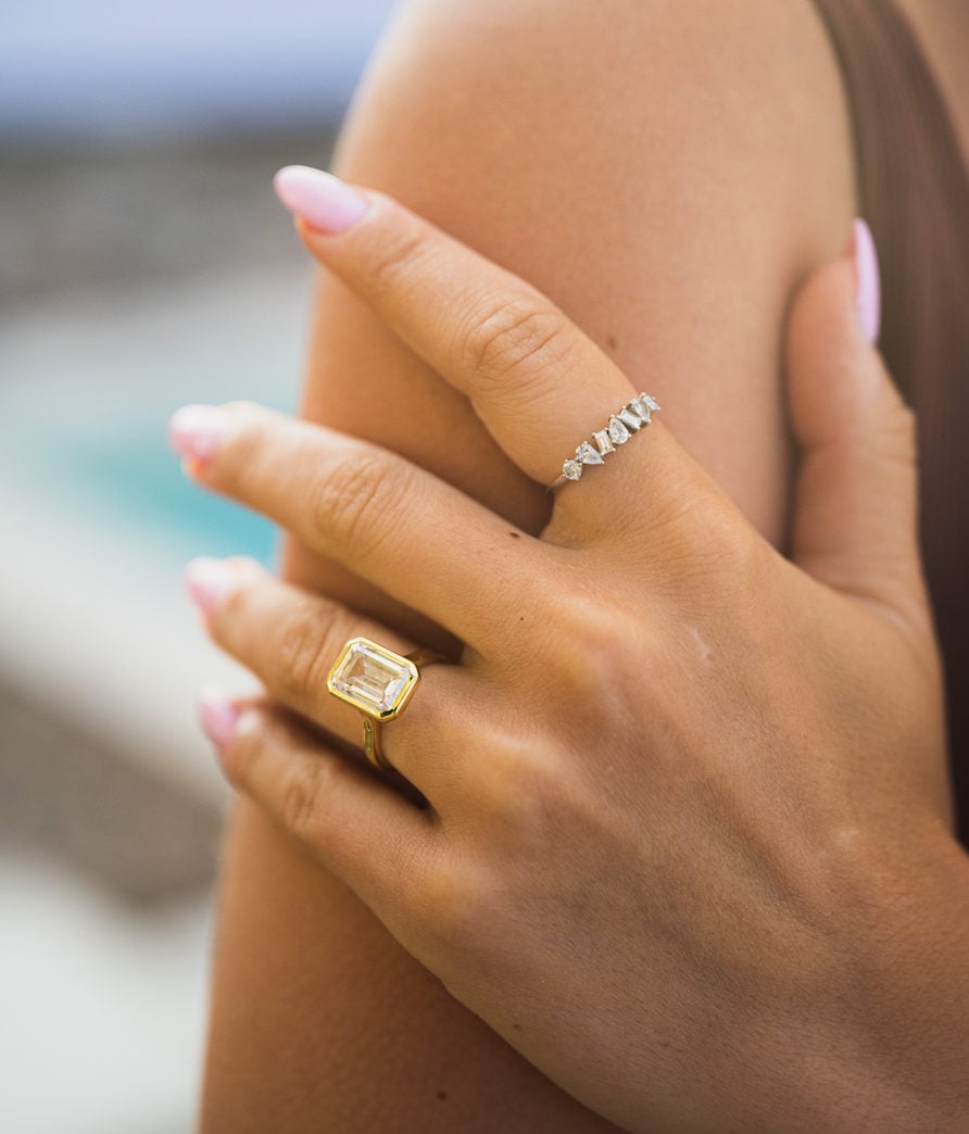 woman wearing bezel emerald ring