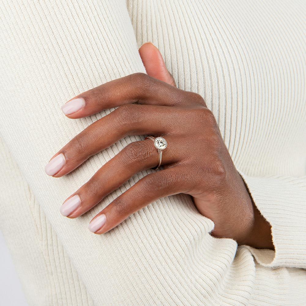 bezel set engagement ring on the ring finger