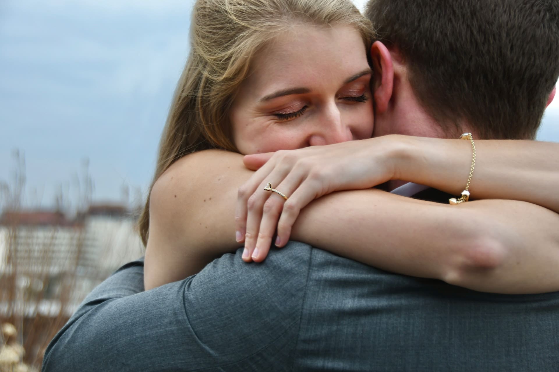couple smiling with engagement ring