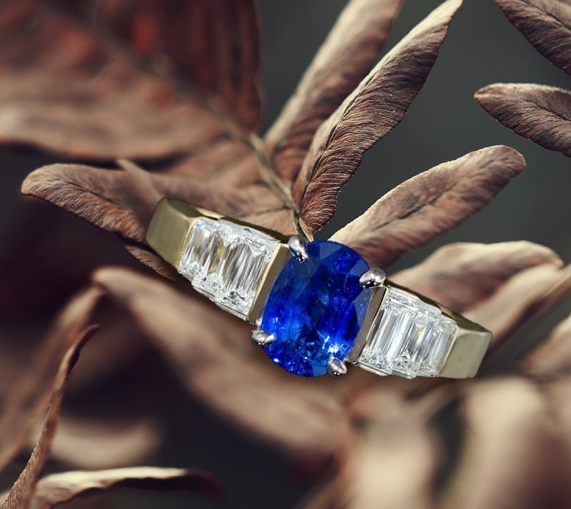 blue sapphire with emerald cut side stones engagement ring