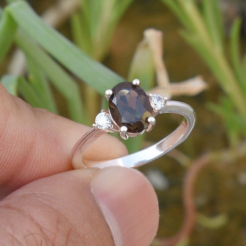 holding a natural smoky quartz silver ring