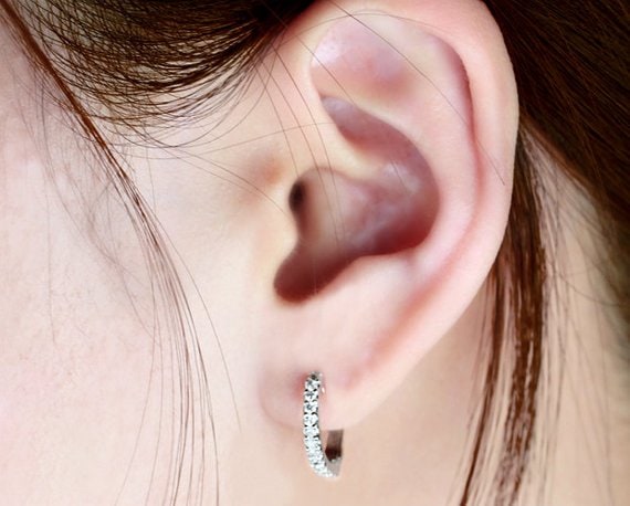 Girl waering small diamond hoops