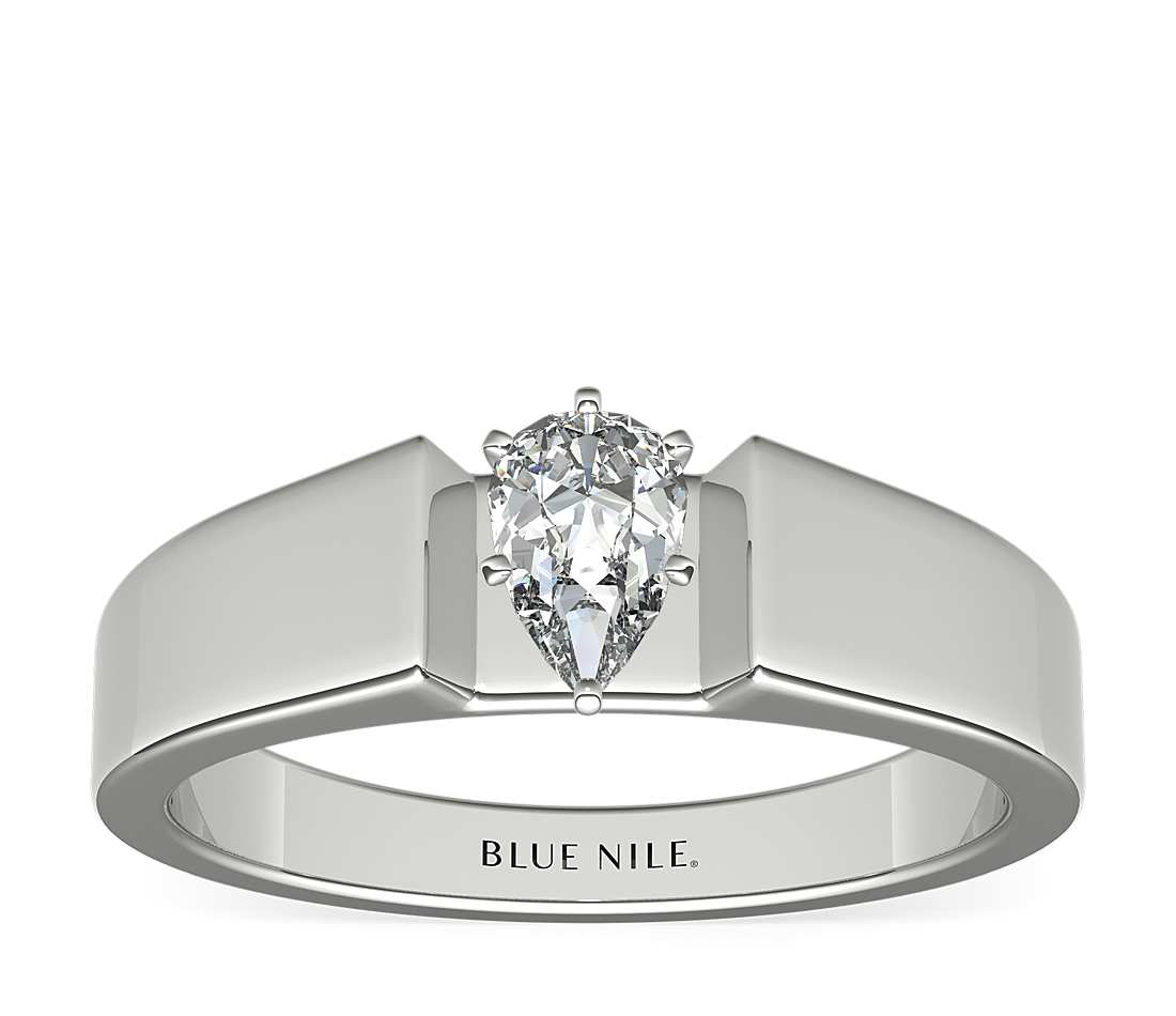 Wide engagement ring with pear shape diamond