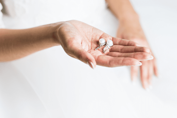 woman holding akoya pearls in hand
