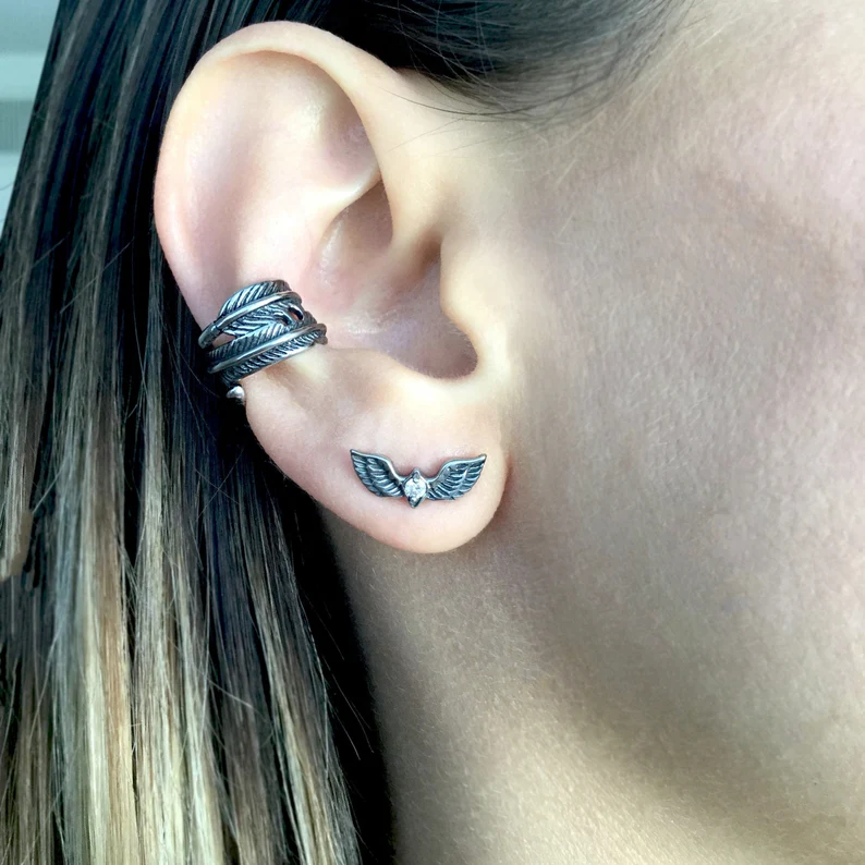 phoenix wings earring on the ear